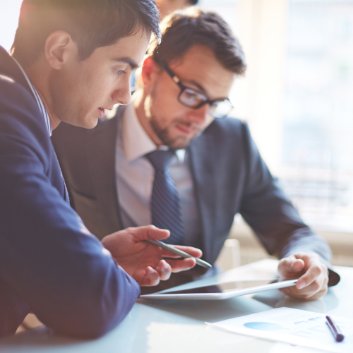 Business people discussing data on a tablet