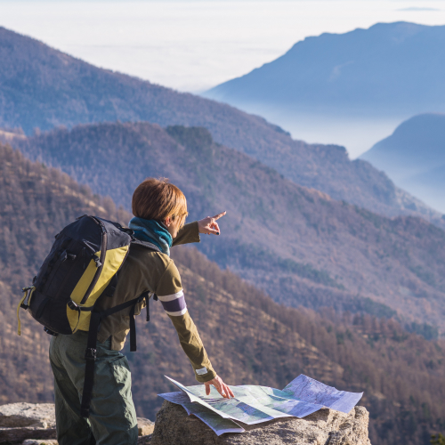 Hiker consulting map and pointing