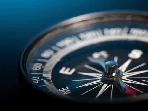Compass with shallow depth of field pointing north