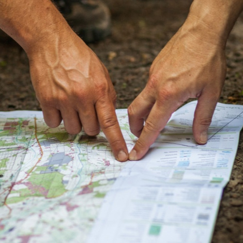 Conducive Compass fingers pointing at map